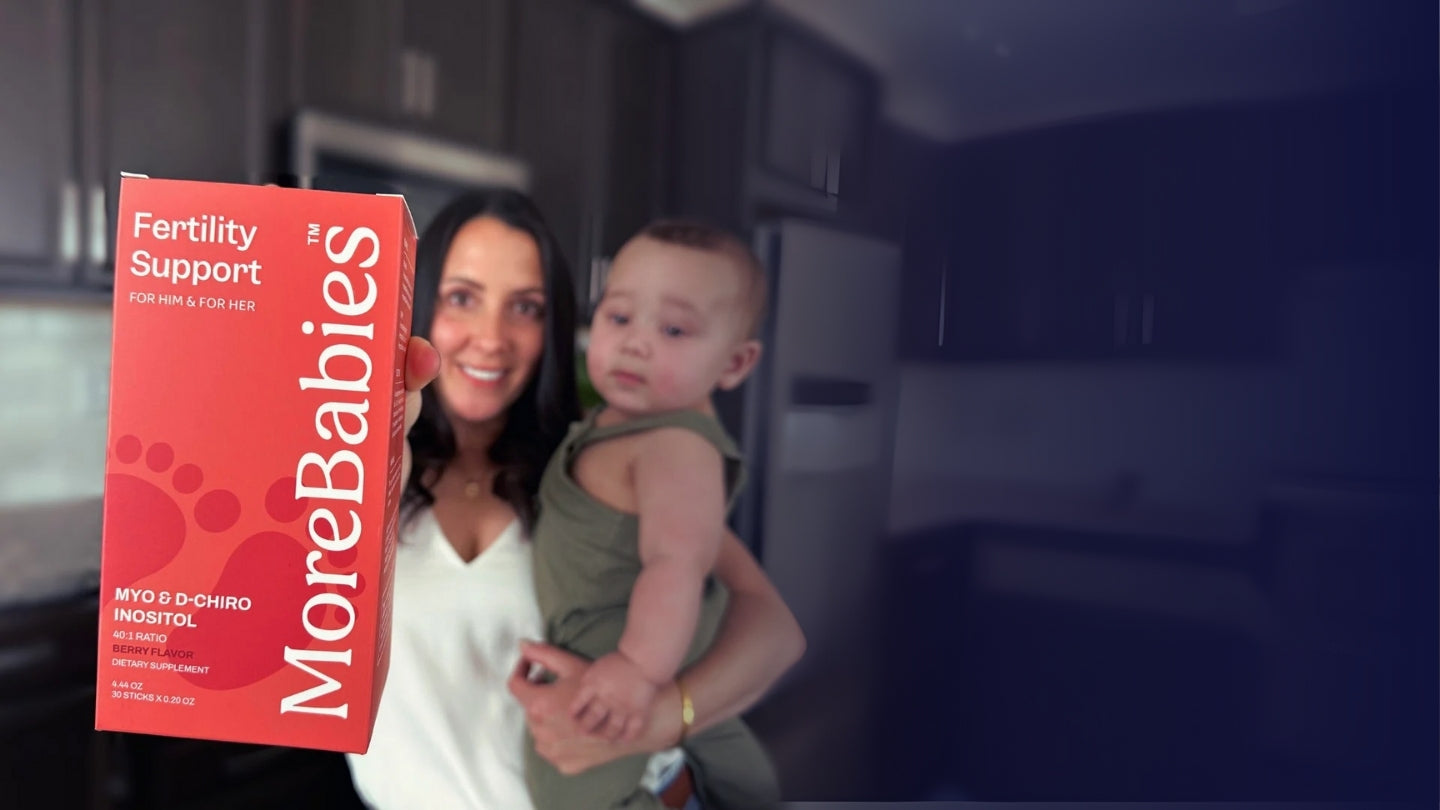 A happy mom and baby, holding a MoreBabies Fertility Support box.